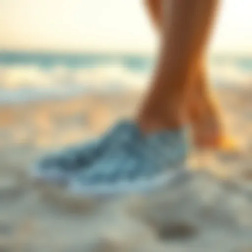 Stylish beach slip-on shoes on sandy shore