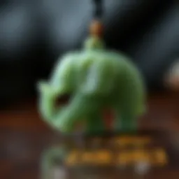 A close-up view of a jade elephant pendant showcasing intricate carvings