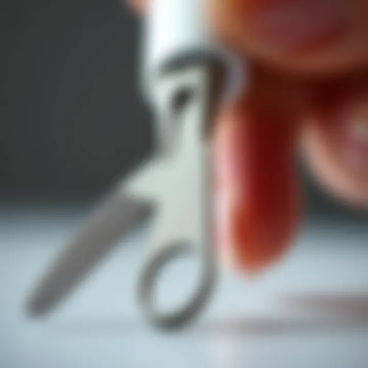 Close-up of a nail scraper demonstrating its ergonomic handle and sharp edge