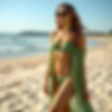 Elegant green bathing suit cover up on a sandy beach